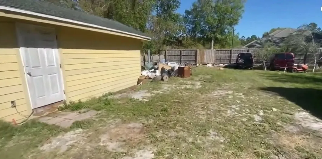 Old appliances and household junk staged in backyard for Miami pickup