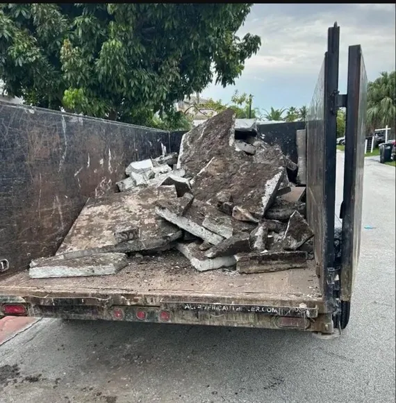 Trailer loaded with concrete rubble and demolition debris for removal in Miami