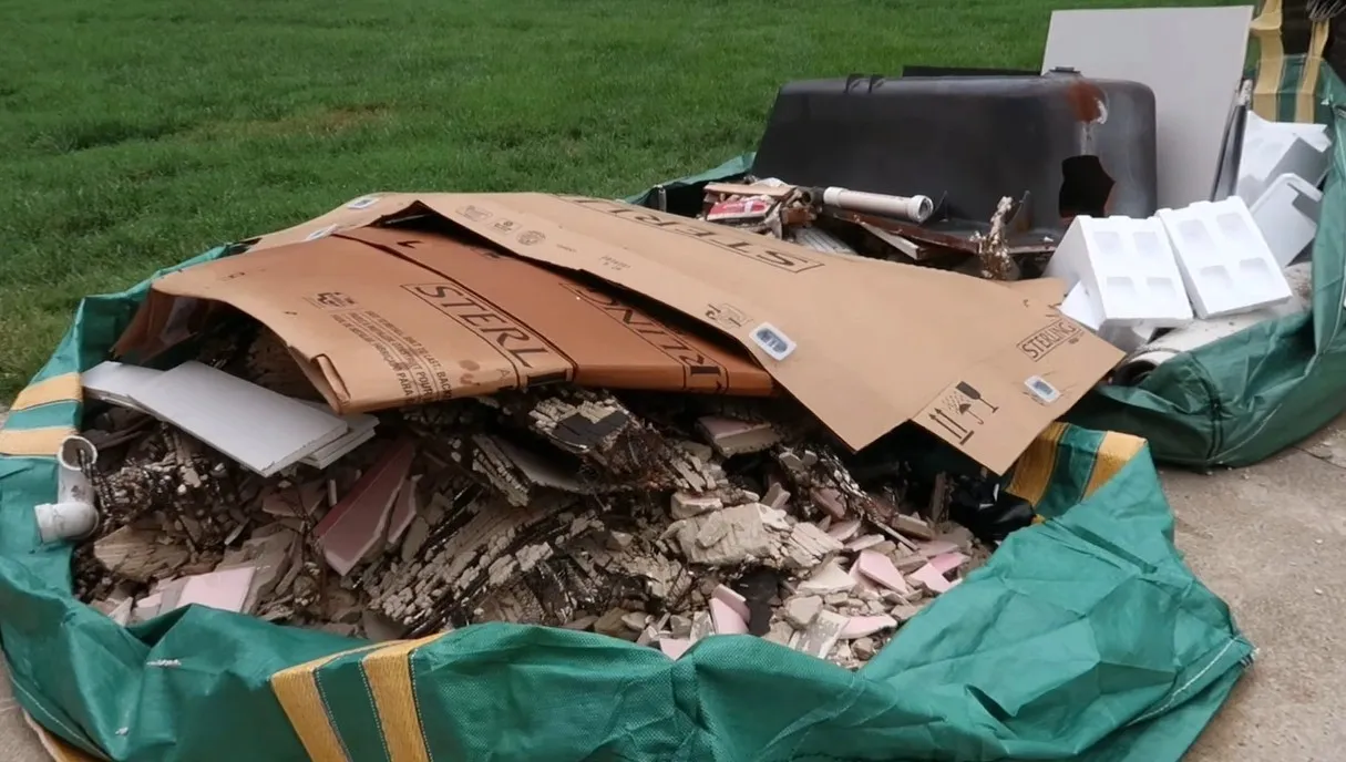 Residential Junk Removal Miami — Bagged household junk staged for curbside pickup in Miami residential driveway