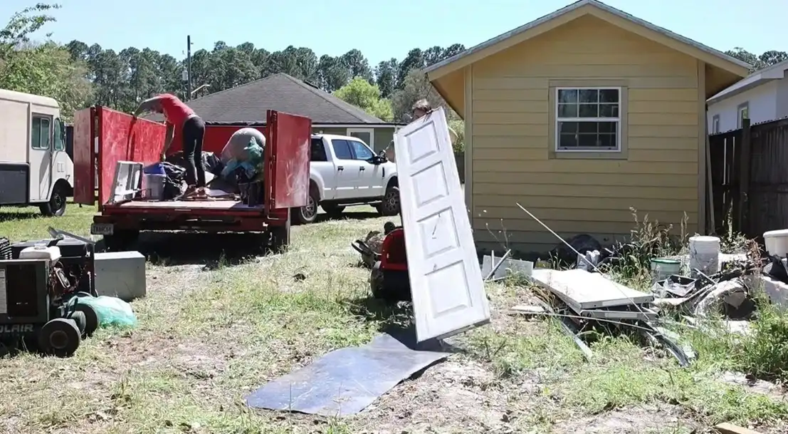 Junk removal crew loading a trailer during a Hialeah duplex cleanout