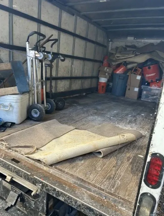 Junk removal truck and equipment staged for a same-day Doral pickup