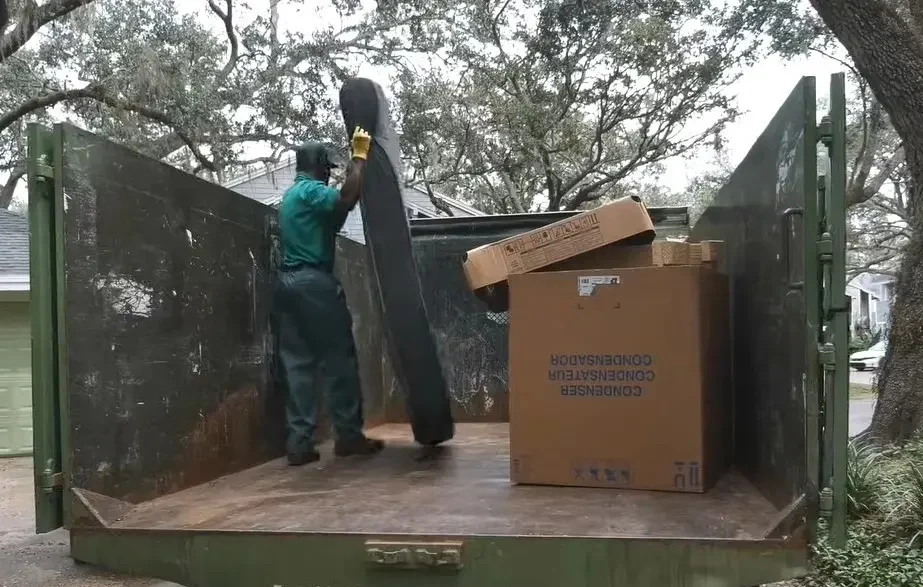 Junk removal worker loading a truck for a Brickell-area job in Miami