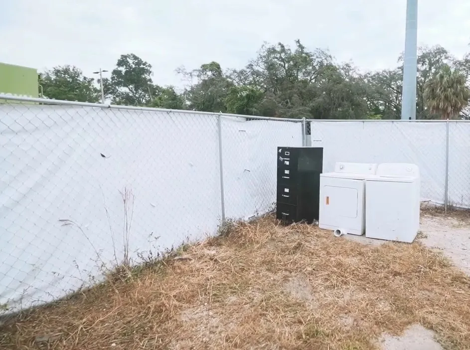 Old washer, dryer, and filing cabinet staged for appliance removal in Miami